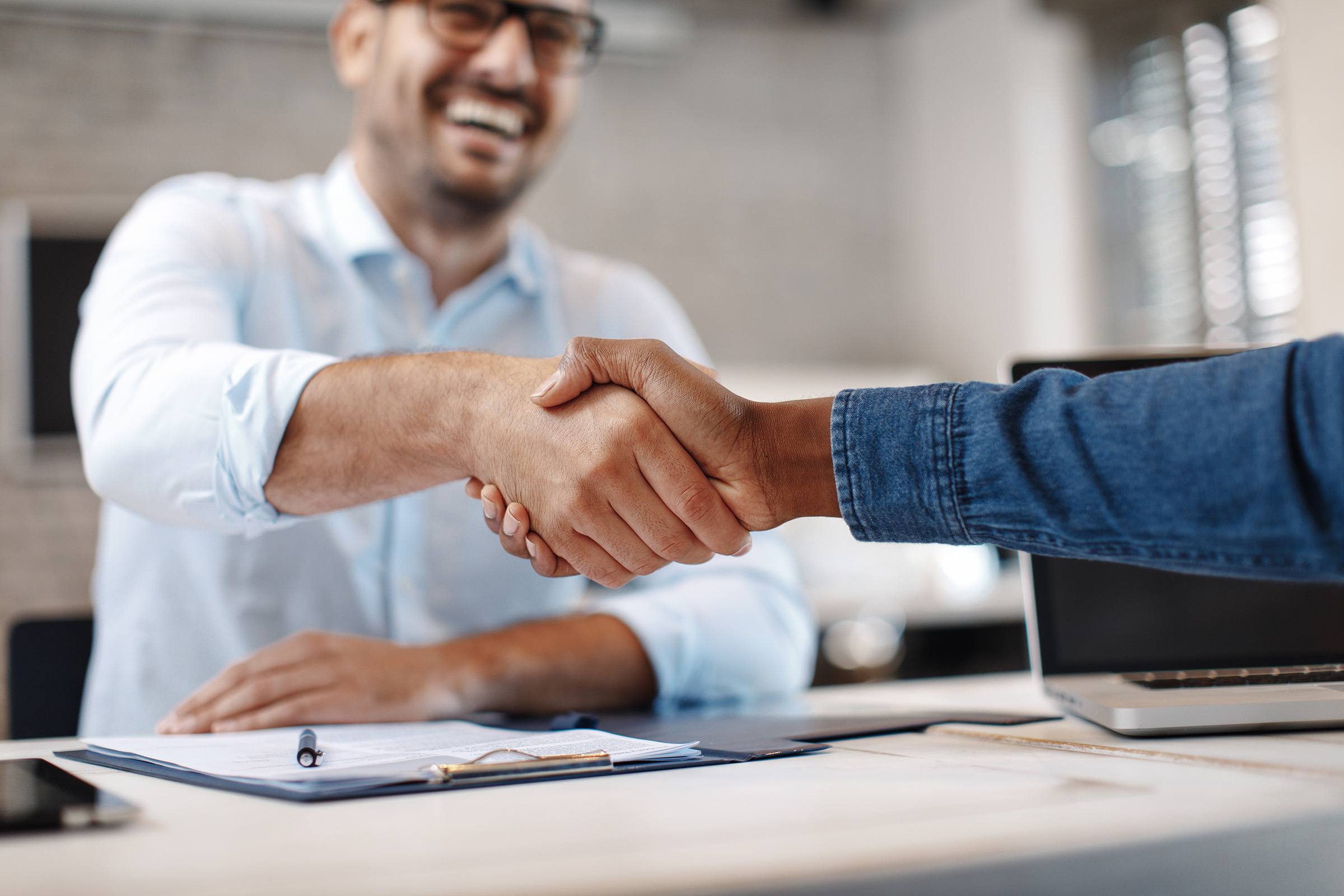People shaking hands on a fitness management agreement.