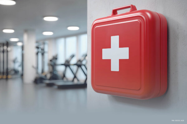 Image of a first aid kit highlighting the importance of fitness facility safety standards